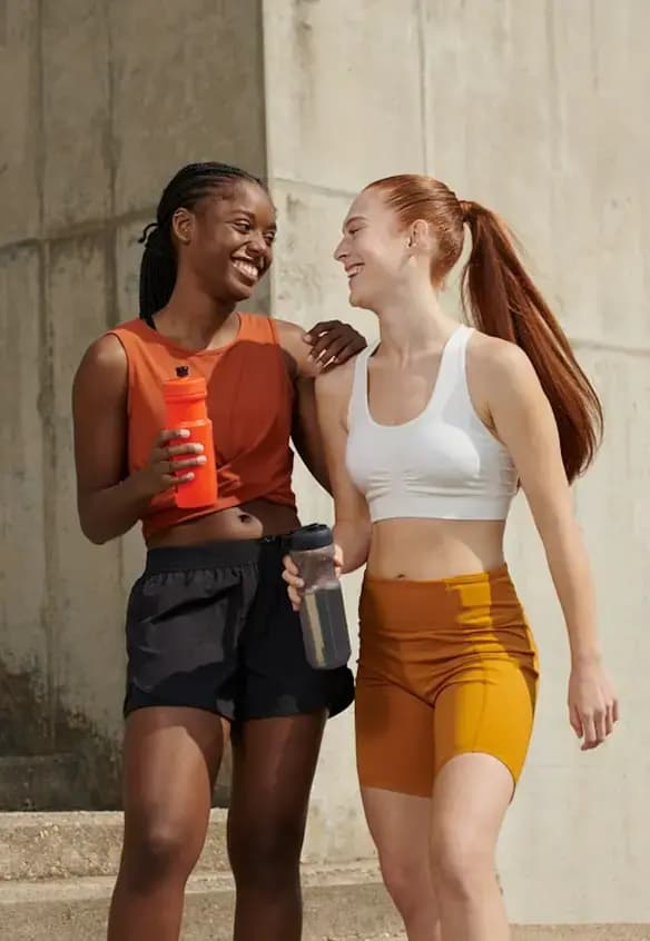 Two women sharing a moment in athletic wear